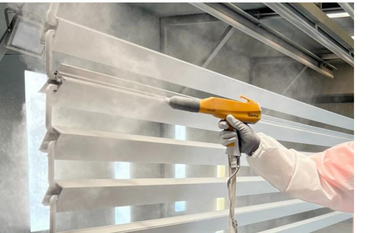 Powder coating spray gun applying coat to aluminium louver sections at New Indira Steels